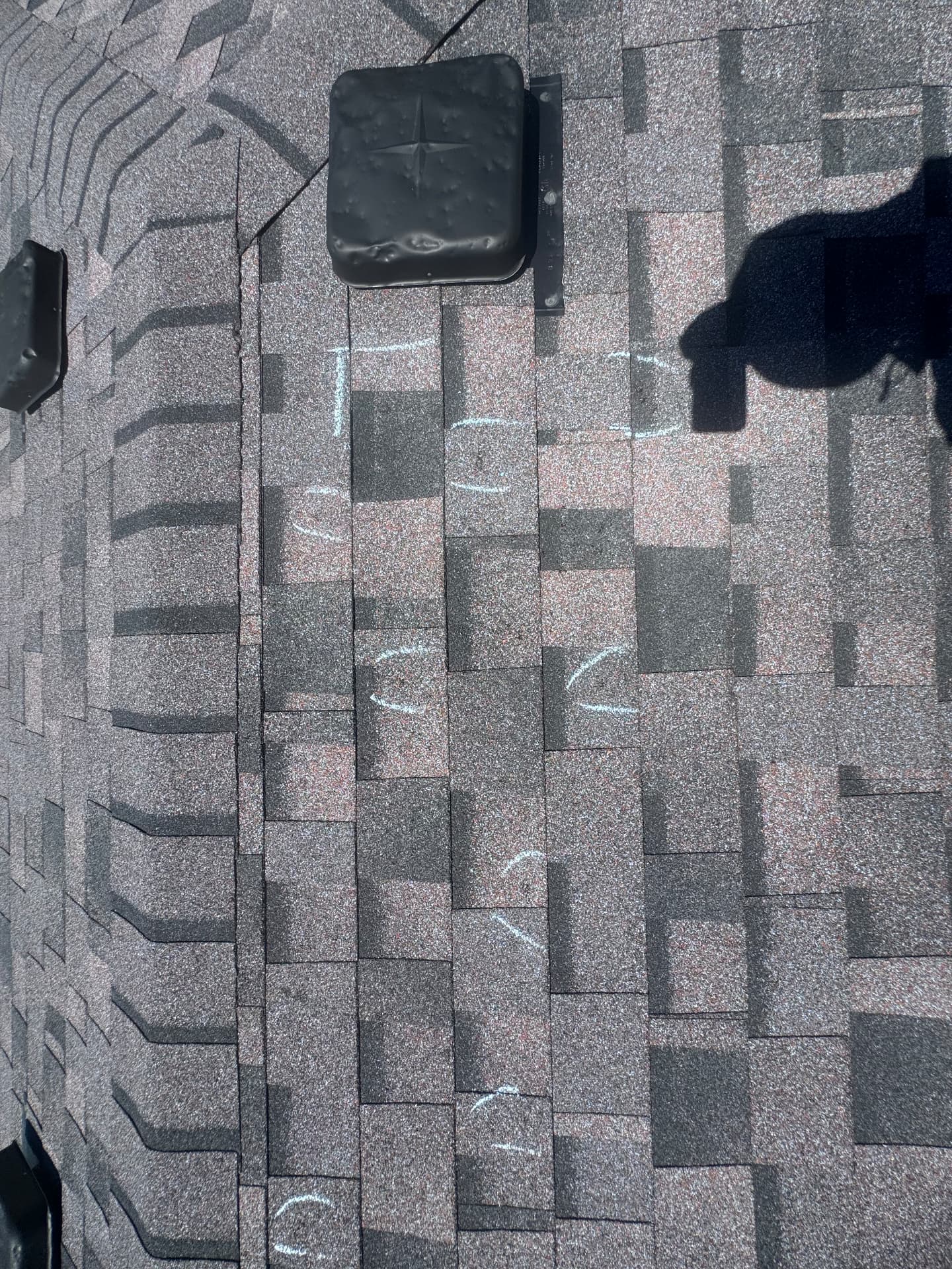 Chalk-marked hail hits documented across shingles during a storm inspection
