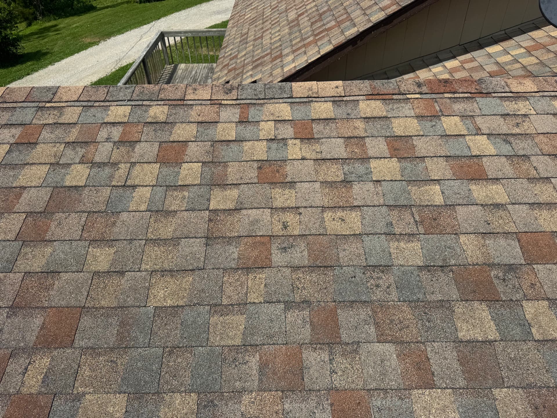 Aging architectural shingles inspected from the ridge of a Missouri home